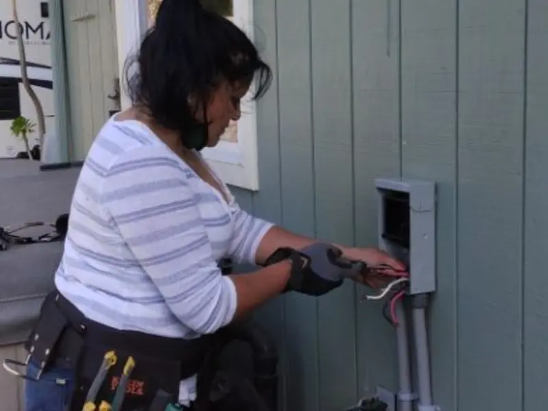 Licensed electrician wiring an exterior subpanel in Seaside